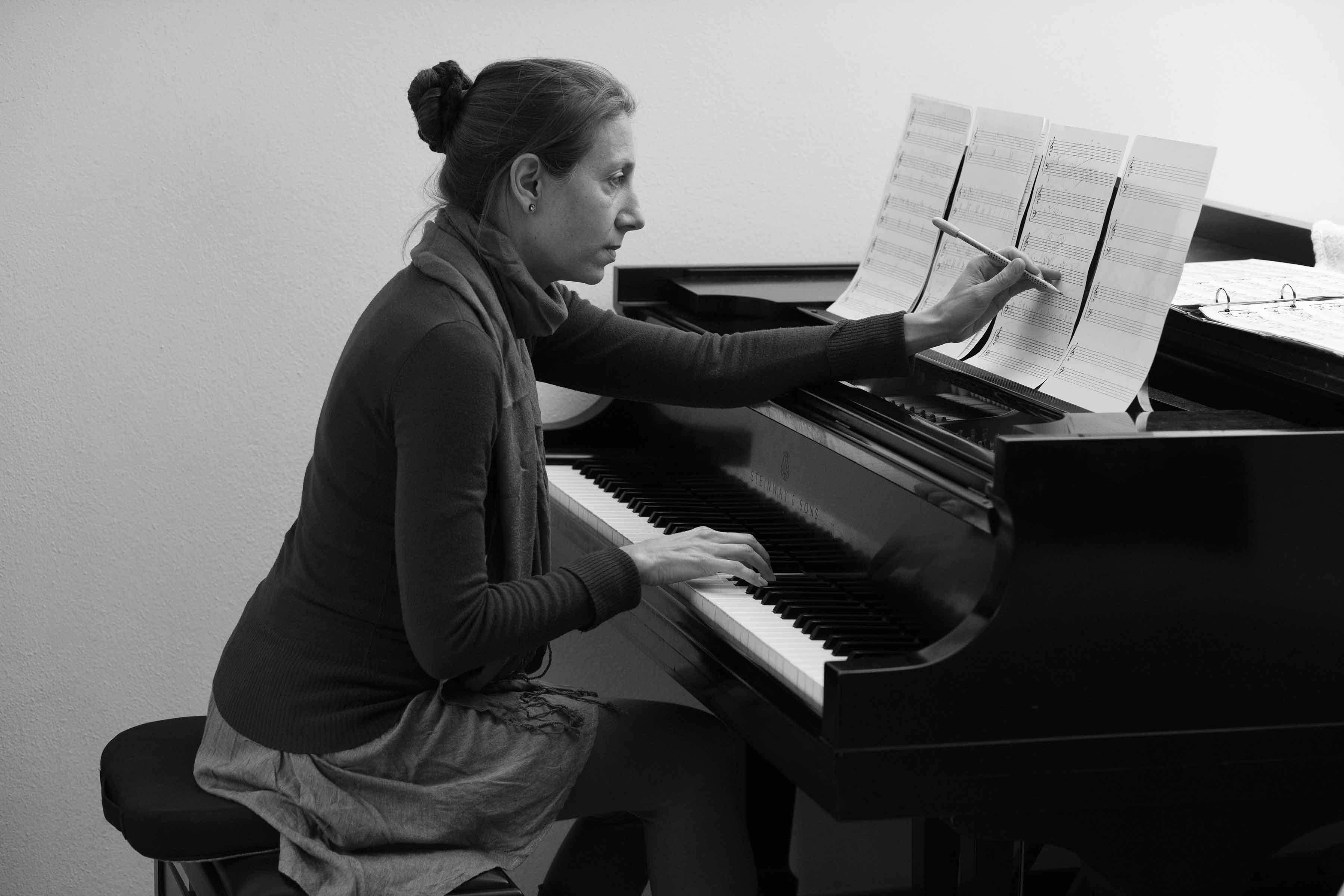 Eva composing at the piano